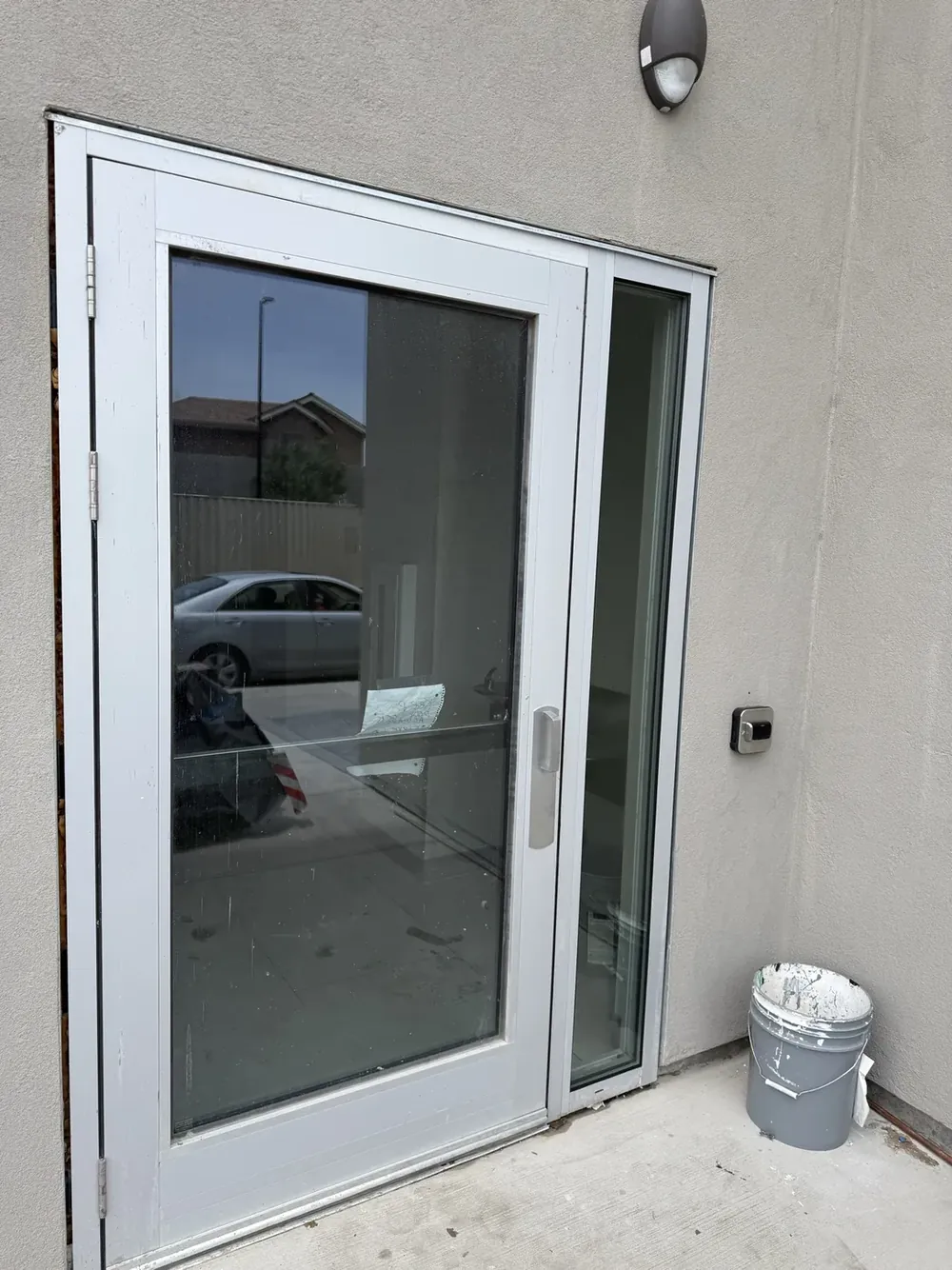 A white-framed glass door with a matching sidelight.