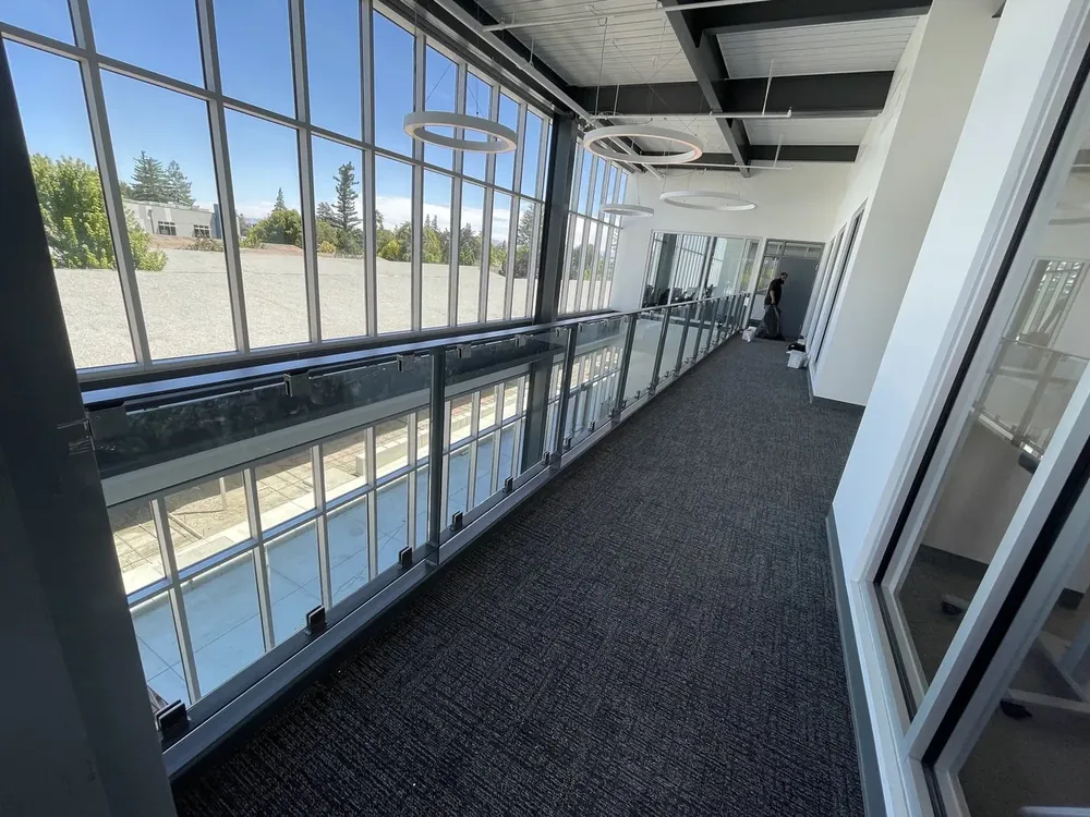 A long run of glazing along the length of an interior corridor.